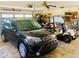 Garage featuring a car and golf cart at 7380 Orange Ave, Indian Lake Estates, FL 33855