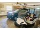 Garage featuring a car and golf cart at 7380 Orange Ave, Indian Lake Estates, FL 33855