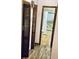 Hallway view leading to a bathroom, showing the interior features of the house at 7380 Orange Ave, Indian Lake Estates, FL 33855