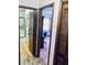 Hallway showcases access to a bathroom with glass shower and a bedroom at 7380 Orange Ave, Indian Lake Estates, FL 33855