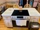 Kitchen island with cooktop and seating at 7380 Orange Ave, Indian Lake Estates, FL 33855