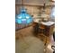Kitchen area with island seating, overhead lighting, and wood cabinets at 7380 Orange Ave, Indian Lake Estates, FL 33855