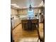 Spacious kitchen with wood cabinets, island with seating, and stainless-steel appliances at 7380 Orange Ave, Indian Lake Estates, FL 33855