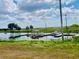 Indian Lake Estates lake view featuring a boat dock and picturesque scenery at 7380 Orange Ave, Indian Lake Estates, FL 33855