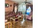 Cozy living room features floral furniture, wood flooring, and decorative wall hangings at 7380 Orange Ave, Indian Lake Estates, FL 33855