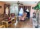 Cozy living room features floral furniture, wood flooring, and decorative wall hangings at 7380 Orange Ave, Indian Lake Estates, FL 33855