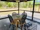 Comfortable patio with dining table and chairs, with relaxing views of the lawn at 7380 Orange Ave, Indian Lake Estates, FL 33855