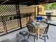 Cozy patio with dining table, chairs, and a ceiling fan for comfortable outdoor dining at 7380 Orange Ave, Indian Lake Estates, FL 33855
