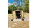 Open shed, paved tile pad, and a secure, covered space for projects or extra storage at 7380 Orange Ave, Indian Lake Estates, FL 33855