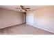 Neutral bedroom with carpet flooring, a ceiling fan, closet and an open door at 810 Sylvia Dr, Deltona, FL 32725