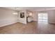 Inviting dining room with wood floors leading to the kitchen and outdoor screened-in patio at 810 Sylvia Dr, Deltona, FL 32725