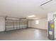 Spacious two car garage features a garage door, an open window, a utility closet and gray flooring at 810 Sylvia Dr, Deltona, FL 32725