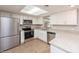 Modern kitchen featuring stainless steel appliances, light cabinets, and granite countertops at 810 Sylvia Dr, Deltona, FL 32725