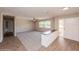 Bright living room with new carpet, and wood-look floors showing an open concept design at 810 Sylvia Dr, Deltona, FL 32725