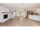 Spacious living space featuring wood floors, a fireplace, and an open kitchen with stainless appliances at 810 Sylvia Dr, Deltona, FL 32725