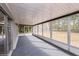 A screened porch with durable carpet, offers seamless indoor-outdoor living at 810 Sylvia Dr, Deltona, FL 32725