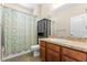 Traditional bathroom featuring a shower with tub, vanity, and neutral decor at 8832 Ribault Ave, Orlando, FL 32832