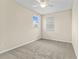 Bright bedroom with neutral walls, carpet, and natural light streaming through the window at 8832 Ribault Ave, Orlando, FL 32832