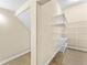 Walk-in closet featuring ample shelving for organized storage at 8832 Ribault Ave, Orlando, FL 32832