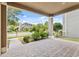 Inviting covered front porch with brick flooring and view of lush landscaping at 8832 Ribault Ave, Orlando, FL 32832