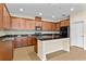 Spacious kitchen with dark wood cabinetry, granite countertops, backsplash and stainless steel appliances at 8832 Ribault Ave, Orlando, FL 32832