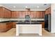 Spacious kitchen with dark wood cabinetry, granite countertops, backsplash and stainless steel appliances at 8832 Ribault Ave, Orlando, FL 32832