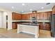 Spacious kitchen with dark wood cabinetry, granite countertops, backsplash and stainless steel appliances at 8832 Ribault Ave, Orlando, FL 32832