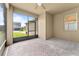 Screened-in outdoor patio with brick floors, ceiling fan, and view of backyard and neighborhood at 8832 Ribault Ave, Orlando, FL 32832