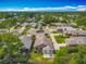 An aerial view of a neighborhood featuring well-maintained homes, mature trees, and lush landscaping under a bright, partly cloudy sky at 907 Silver Leaf Pl, Port Orange, FL 32127