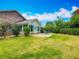 Spacious backyard with lush lawn and patio seating area at 907 Silver Leaf Pl, Port Orange, FL 32127