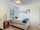 Bedroom featuring a twin bed, decorative artwork, French doors, and side table at 907 Silver Leaf Pl, Port Orange, FL 32127