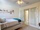 Cozy bedroom with a twin bed, decorative artwork, and French doors at 907 Silver Leaf Pl, Port Orange, FL 32127
