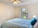 Bedroom featuring a brass bed frame with a ceiling fan and a large window at 907 Silver Leaf Pl, Port Orange, FL 32127
