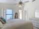 Bright bedroom features a ceiling fan, a sliding door to the outside, and an ensuite bathroom at 907 Silver Leaf Pl, Port Orange, FL 32127