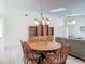Bright dining area with tile flooring, chandelier, and a built-in bookcase for displaying decor at 907 Silver Leaf Pl, Port Orange, FL 32127