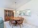 Dining room featuring a wood table and decorative hutch, with a view to the kitchen at 907 Silver Leaf Pl, Port Orange, FL 32127