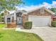 Beautiful brick home with lush green lawn and a two-car garage, offering curb appeal at 907 Silver Leaf Pl, Port Orange, FL 32127