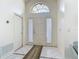 Bright foyer featuring tile flooring, arched window and a classic white front door at 907 Silver Leaf Pl, Port Orange, FL 32127