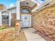 Inviting front entrance with a brick facade, decorative wreath, and manicured landscaping at 907 Silver Leaf Pl, Port Orange, FL 32127