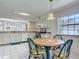 Bright kitchen with a round table, white cabinetry, and ample natural light with view of garage at 907 Silver Leaf Pl, Port Orange, FL 32127
