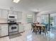 Cozy kitchen with stainless steel range and oven and a view to the Florida Room at 907 Silver Leaf Pl, Port Orange, FL 32127