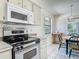 Kitchen with stainless steel oven and microwave, with a small dining table at 907 Silver Leaf Pl, Port Orange, FL 32127