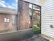 Screened in porch with exposed brick, wood deck, and garden view at 907 Silver Leaf Pl, Port Orange, FL 32127