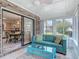 Sunroom with a ceiling fan, cushioned chairs, and view into the kitchen at 907 Silver Leaf Pl, Port Orange, FL 32127