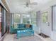 Sunroom with a ceiling fan, cushioned chairs, and lots of natural light at 907 Silver Leaf Pl, Port Orange, FL 32127