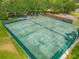 Aerial view of well-maintained community tennis courts, perfect for sports enthusiasts, surrounded by lush greenery at 907 Silver Leaf Pl, Port Orange, FL 32127