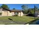 Well-kept house with green grass, a sturdy roof and green trees at 908 Boulder Dr, South Daytona, FL 32119