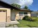 Exterior view of the home featuring an attached garage, front door, and landscaping at 908 Boulder Dr, South Daytona, FL 32119