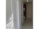 Hallway with new white marble floors, white walls and bright lighting at 908 Boulder Dr, South Daytona, FL 32119