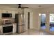 Modern kitchen with stainless steel appliances, a refrigerator and marble floors at 908 Boulder Dr, South Daytona, FL 32119